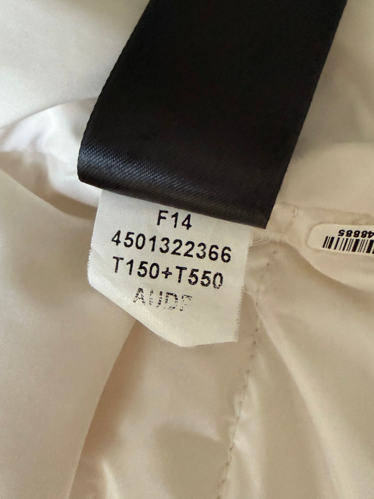 The North Face cream down puffer vest label
