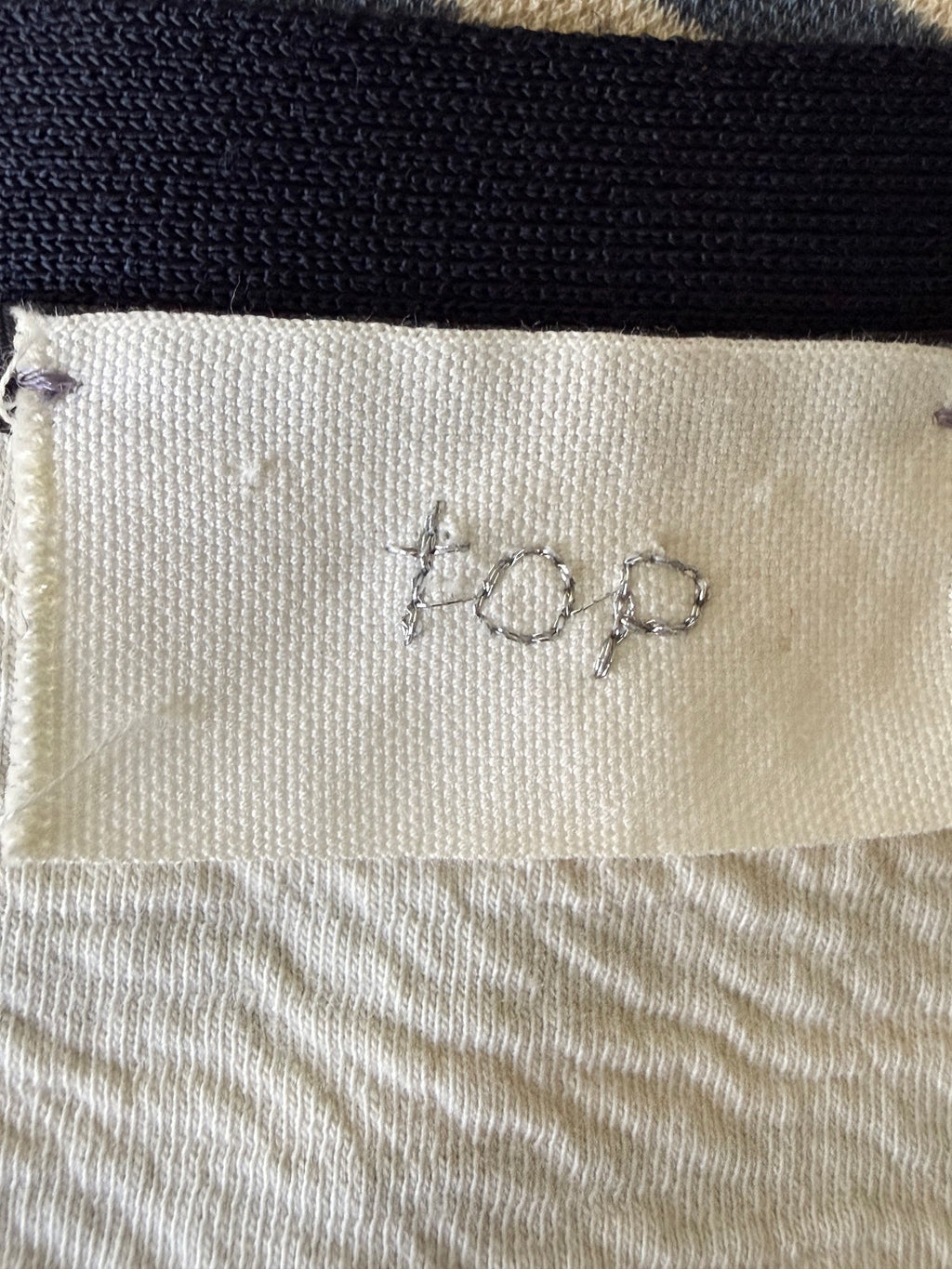 navy and cream Breton striped top label