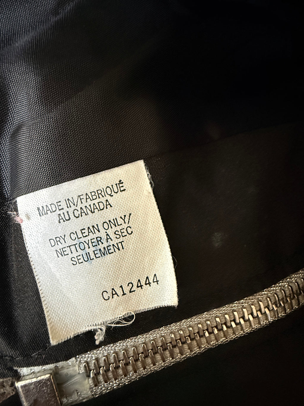 Nina Midvani black zip-front padded vest label