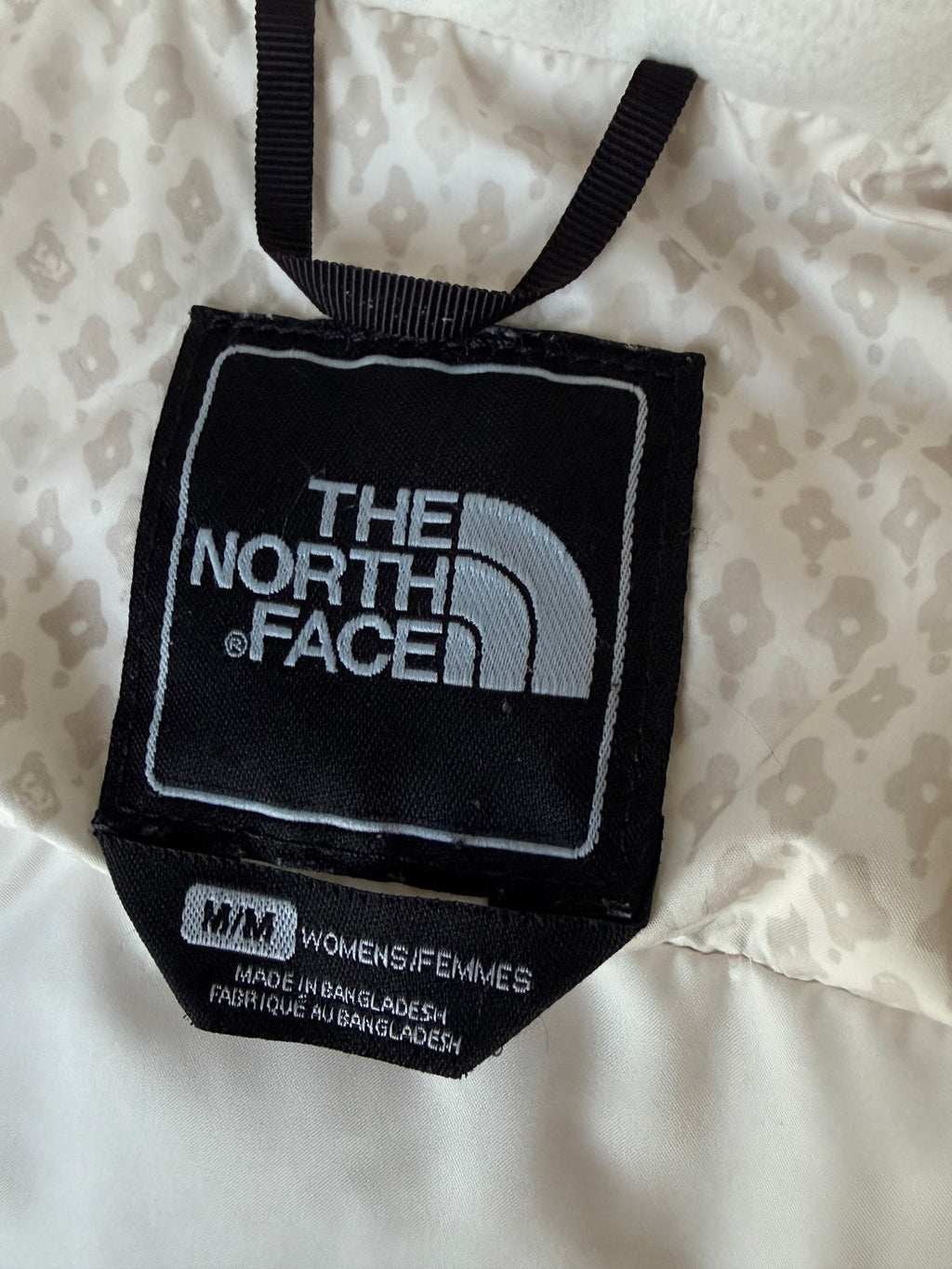 The North Face cream down puffer vest label