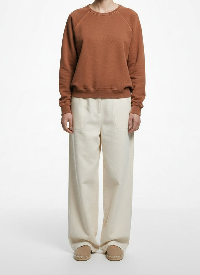 Full body view of the model wearing The Great. Terracotta Cotton Raglan Sweatshirt Size 1