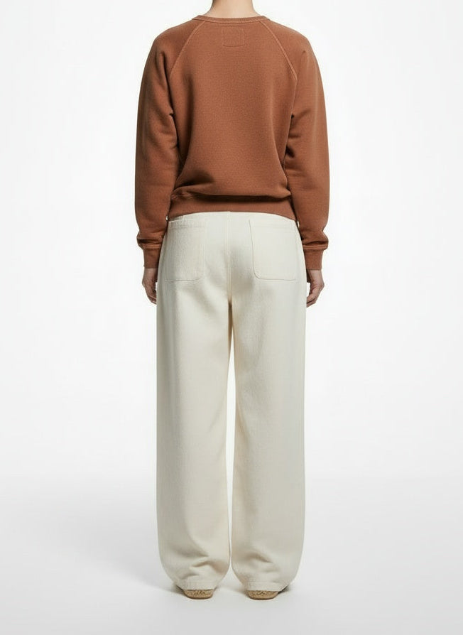 Back pose of the model wearing The Great. Terracotta Cotton Raglan Sweatshirt Size 1