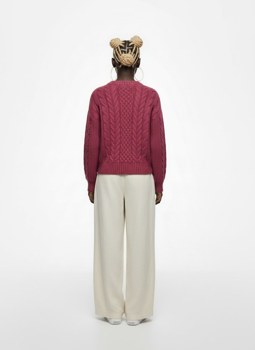 Back pose of the model wearing Munrospun Rose Pink Pure New Wool Cable-Knit Sweater Small