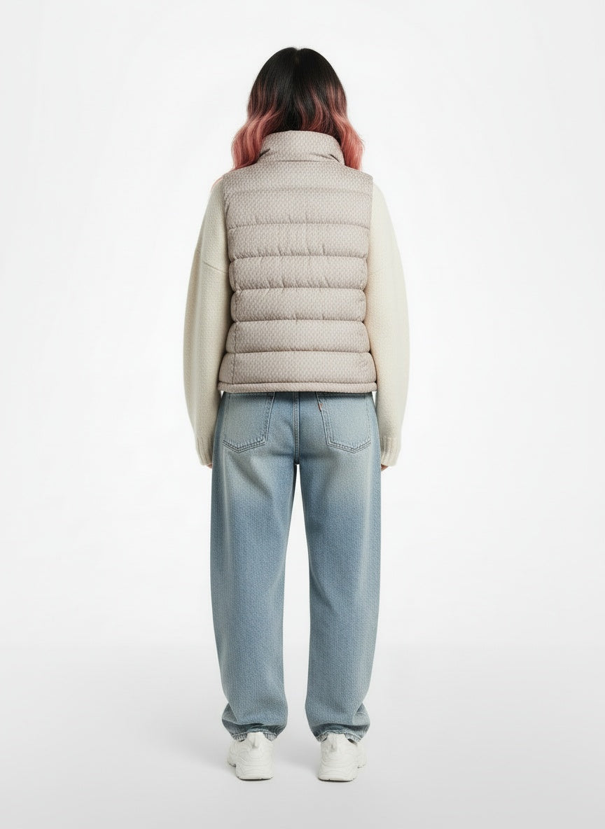 Back pose of the model wearing The North Face Cream Down Puffer Vest Women's Medium